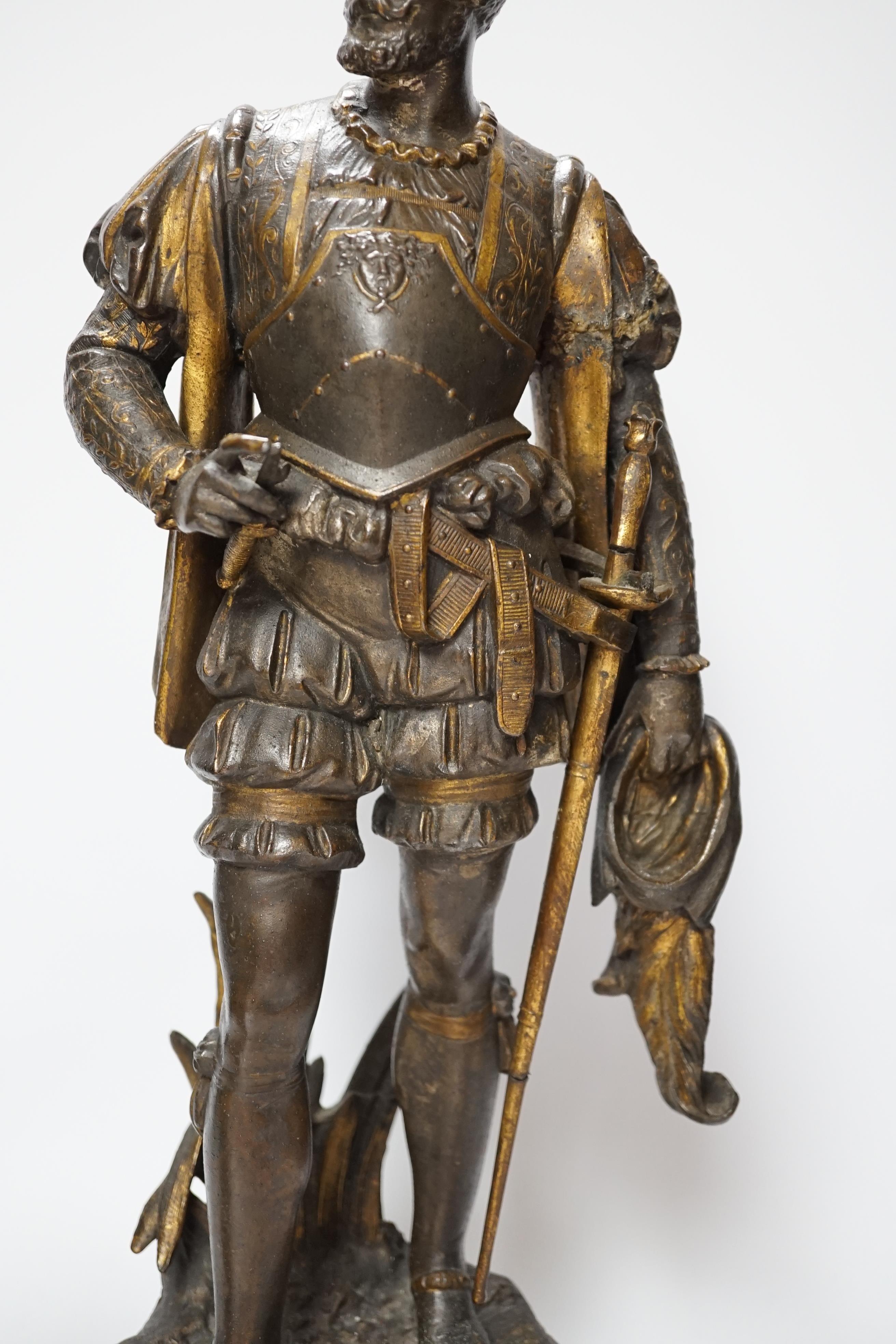 A 19th century parcel gilt and bronzed spelter figure of a cavalier, together with a Florentine style bronze ewer, 49cm high (the latter a.f.) (2)